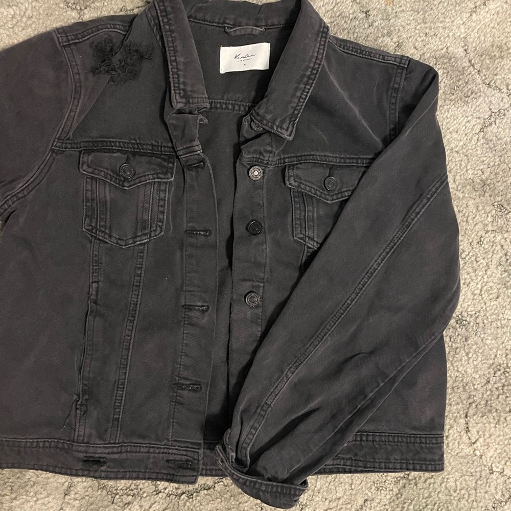 Black jean jacket, black buttons, small crop, functional pockets.